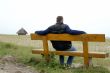Man is sitting on a bench
