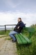 Man is sitting on a bench