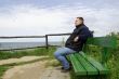 Man is sitting on a bench