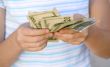 Child counting money (Shallow DOF)