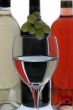 wine glasses with reflection of  wine bottles
