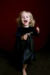 happy little girl in party dress with toy