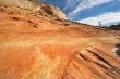 Orange striped slope and plumose clouds