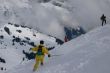 Yellow skier traversing steep slope