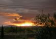  Sun setting  into the Rain Clouds