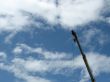 Single construction crane against blue sky