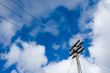 telegraph pole over blue sky background