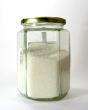Glass jar with white a granulated sugar