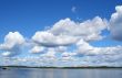 blue sky with curly white clouds above the lake