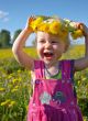 happy girl with dandelion wreath
