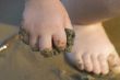 child`s hand with sand