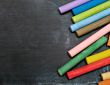 blackboard with coloured crayons