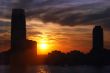 skyline and skyscrapers with water and setting sun