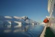 Cruise ship with lifeboat, mountains