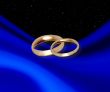 Wedding rings on dark blue drapery