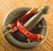 stone mortar with red chillies