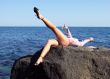 The sexual girl lays on a stone