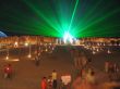 The green laser at night above a beach