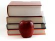 apple in front of books