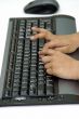 Hands typing on a computer key board