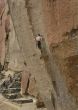 Climber on overhanging cliff