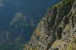 Steep layered cliff and forest valley