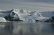 Mountains & glaciers reflected in calm ocean