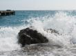 cold sea waves crashing against the coast stone