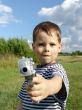 Little boy with toy-pistol