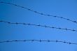 Barbed wire against a blue sky