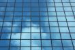 sky reflecting in windows of office building