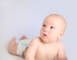 Funny little baby on grey