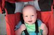 Baby sitting in stroller. Close-up #1