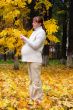 Pregnant woman in autumn park hold maple leaf #1