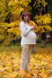 Pregnant woman in autumn park hold maple leaf #5