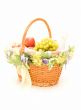 Fruit basket with a bottle of champagne on white