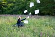 Businesswoman on nature with laptop catch documents #2