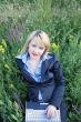 Businesswoman on grass with laptop 2
