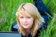 Girl with flower in hair lying on grass #1