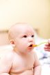 Baby eating by plastic spoon