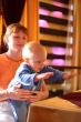 Mother holding enjoying baby slaping by hands
