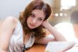 Attractive girl reading document in consultative room