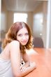 Smiling pretty brunette in a room #2