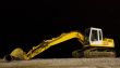 excavator on night pebble beach mounting tube
