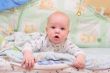 Baby rest on bed and look at camera #1