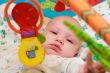 Baby playing with toys. Little boy touching the toy by finger.