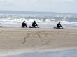 Three Surfers