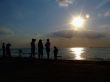 Silhouette of people looking at windsurf