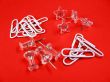 Paper clips and push pins over red background