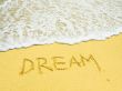 dream word written in the sandy beach